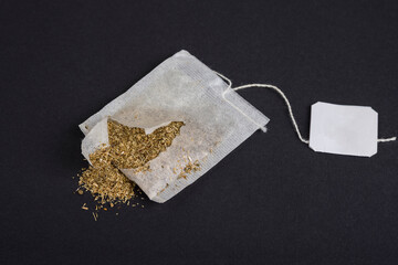 Broken Herbal Tea bag on a black background