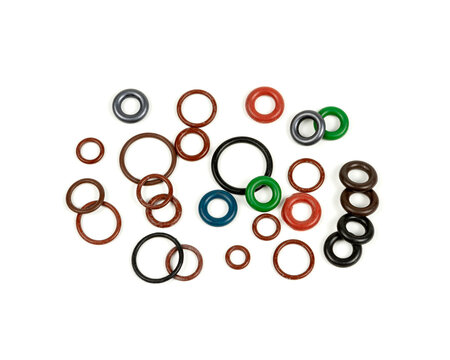 Hydraulic and pneumatic o-rings in different sizes and colors, on a white background. Various seals for plumbing. Sealing rings for hydraulic connections.