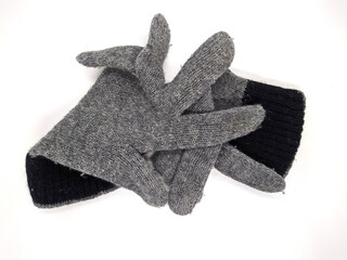 pair of two warm woolen knitted gloves isolated on white background.
