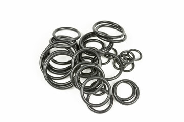 Hydraulic and pneumatic o-rings in black in different sizes on a white background. Various seals for plumbing. Sealing rings for hydraulic connections.