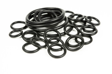 Hydraulic and pneumatic o-rings in black in different sizes on a white background. Various seals for plumbing. Sealing rings for hydraulic connections.