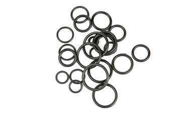 Hydraulic and pneumatic o-rings in black in different sizes on a white background. Various seals for plumbing. Sealing rings for hydraulic connections.