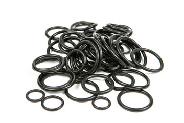 Hydraulic and pneumatic o-rings in black in different sizes on a white background. Various seals for plumbing. Sealing rings for hydraulic connections.