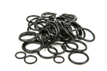 Hydraulic and pneumatic o-rings in black in different sizes on a white background. Various seals...