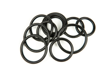 Hydraulic and pneumatic o-rings in black in different sizes on a white background. Various seals for plumbing. Sealing rings for hydraulic connections.