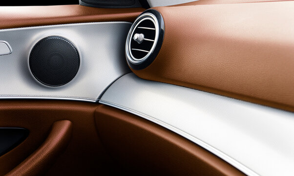 Car door handle inside the luxury modern car with brown leather texture with stitching. Switch button control. Modern car interior details. Orange perforated leather