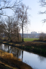 River Glatt near the airport with reflections of trees on a beautiful winter afternoon. January 13th, 2022, Zurich, Switzerland.