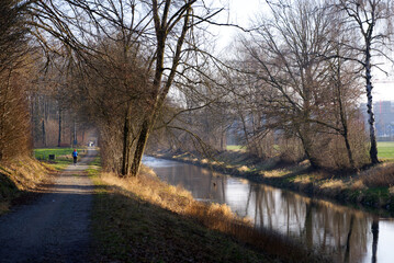 River Glatt near the airport with reflections of trees on a beautiful winter afternoon. January 13th, 2022, Zurich, Switzerland.