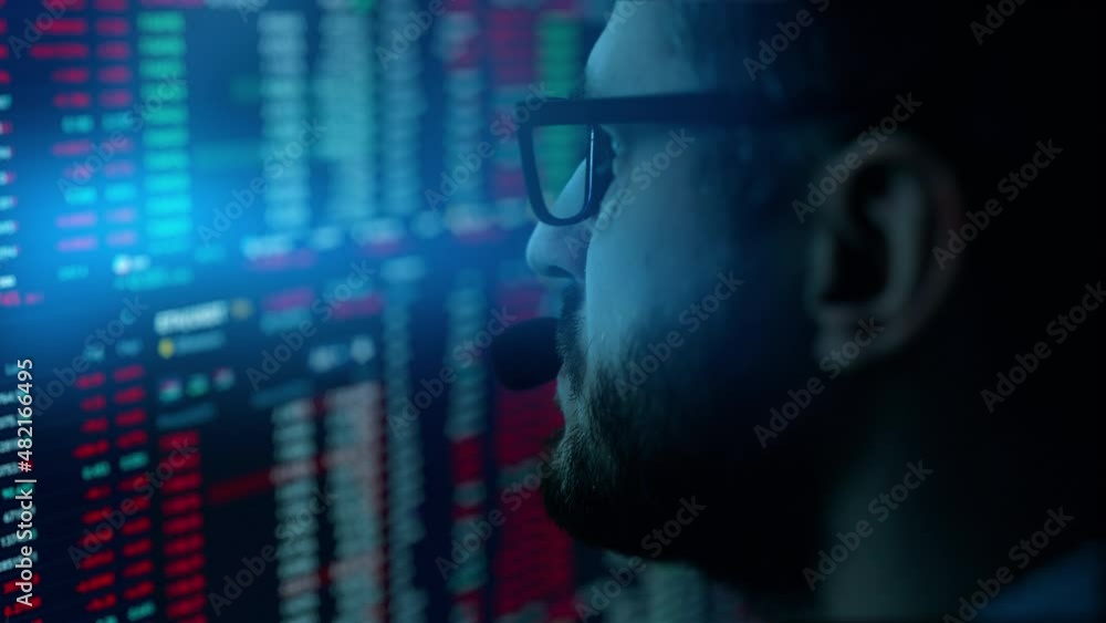 Poster trader is working with multiple computer screens with charts and data analysis and stock broker trad