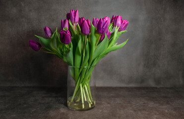 a bouquet purple dutch tulips in a vase