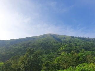 Fototapeta na wymiar Amazing Blue Sky above the Green Mountain