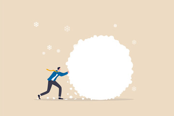 Snowball effect from small build up larger with potential risk, financial growth or mistake concept, businessman investor rolling large snowball build up from small getting bigger.