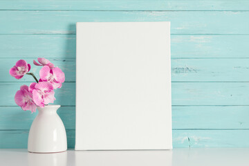 Beautiful flowers composition. Photo frame, pink orchid flower on pastel turquoise background....