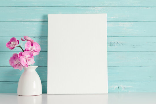 Beautiful flowers composition. Photo frame, pink orchid flower on pastel turquoise background. Valentines Day, Happy Women's Day. 