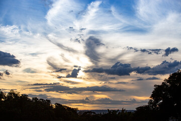 Dramatic sky with gray clouds and a background of blue and orange sky at dawn