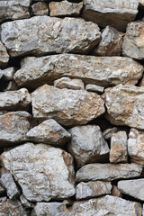 Stone wall. Rock background of crushed rocks stacked on top of each other.