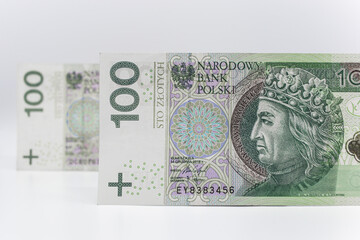 One hundred zloty - Polish banknote. Polish currency on a white background arranged in a pattern. Illustrates cash flow and business
