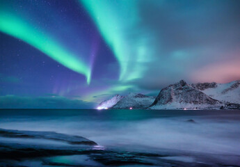 Fototapeta na wymiar Aurora borealis in Norway. Green northern lights. Night winter landscape with aurora. Natural background in Norway.