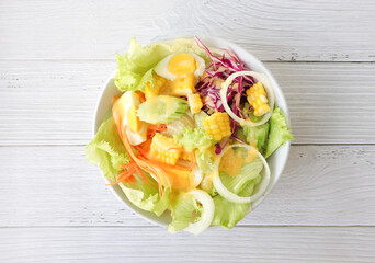 Fresh salad top view on gray wooden table
