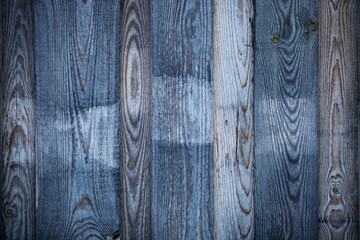 Obraz premium Dark wood boards texture close up. Vintage wooden surface background. Unpainted natural hardwood boards texture. Weathered surface of the old planks of wooden wall close-up. High contrast wood.
