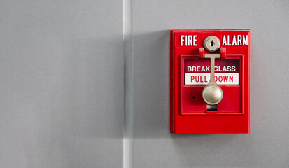 An office building's fire alarm switch is mounted on the wall.