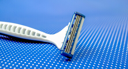 man's razor on a blue dots background. Close-up.