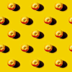 red Apple pattern on bright yellow background. Minimal flat lay food texture. Summer abstract trendy fresh concept.