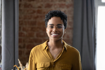 Happy millennial Afro American business lady head shot portrait. Young Black short haired professional woman, leader, entrepreneur profile picture. Smiling confident employee looking at camera