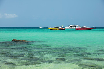 Clear Blue sea on island beach with travel speed boat service
