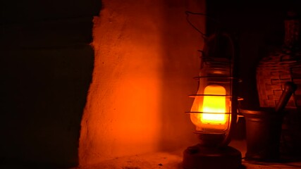Close-up of a classic incandescent lamp. Glass bulb, inert gas and tungsten filament. Soft natural light. Lamp velvet effect. Is flaring up brighter and brighter.