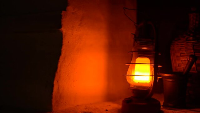 Close-up of a classic incandescent lamp. Glass bulb, inert gas and tungsten filament. Soft natural light. Lamp velvet effect. Is flaring up brighter and brighter.