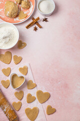 Fototapeta na wymiar Cooking cookies for valentine's day with ingredients on a pink background