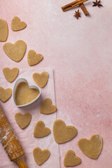 Fototapeta premium Cooking cookies for valentine's day with ingredients on a pink background