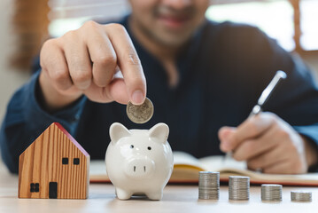 the person putting coin into piggy bank to save money and invest for growth in future.