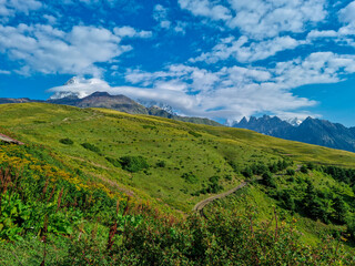 A panoramic hiking trail leading to the Koruldi Lakes in the Greater Caucasus Mountain Range in Georgia, Upper Svanet Region. Panoramic view on the Ushba mountain peaks.Wanderlust.Ushba Mountain Peak
