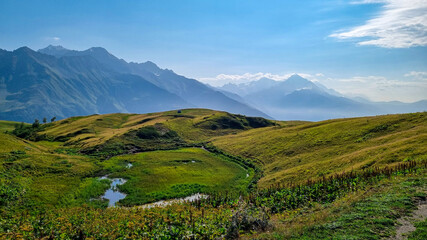 A pond and an amazing view on the sharp Svaneti mountain peaks near Mestia in the Greater Caucasus Mountain Range, Upper Svaneti, Country of Georgia.Hiking trail to the Koruldi Lakes.