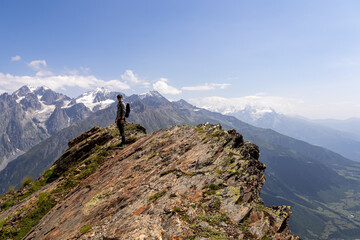 A male hiker enjoying the amazing views on the mountain ridges in the Greater Caucasus Mountain Range in Georgia, Samegrelo-Upper Svaneti Region. Freedom. Wanderlust. Trekking to Koruldi Lakes