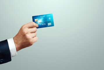 Credit card in the hand of a businessman close-up. Payment with nfc, contactless payment system, shopping, electronic money.
