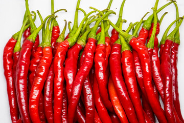Red hot chili pepper isolated on a white background.
This pile of red chilies is commonly used as a...