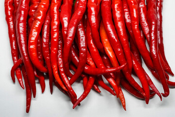 Red hot chili pepper isolated on a white background.
This pile of red chilies is commonly used as a...