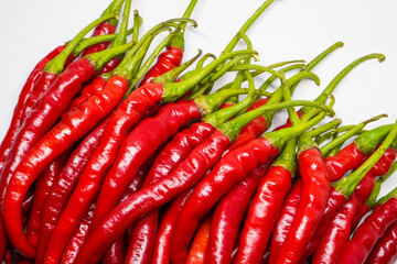 Red hot chili pepper isolated on a white background.
This pile of red chilies is commonly used as a...