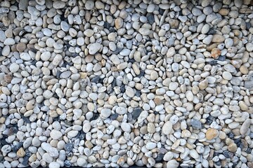 Smooth round pebbles texture background. Pebble sea beach close-up, dark wet pebble and gray dry pebble.