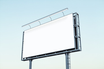Blank white billboard on blue sky background at sunset, perspective view. Mockup, advertising concept