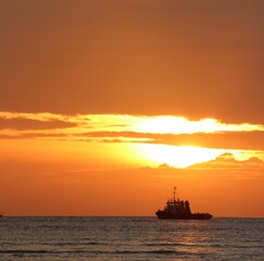 Fototapeta premium mud dredgers boat at sunset