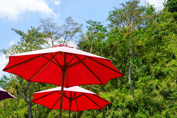 Colored umbrellas at an outdoor cafe in the tourist area of ​​​​the muria mountains, Central Java, Indonesia.