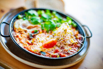 Egg shakshouka dish on a restaurant table