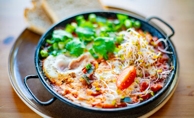 Egg shakshouka dish on a restaurant table
