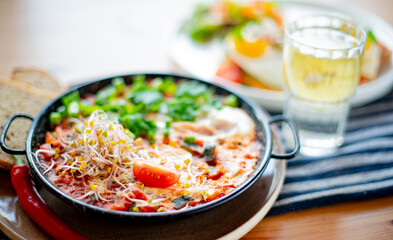 Egg shakshouka dish on a restaurant table