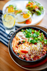 Egg shakshouka dish on a restaurant table