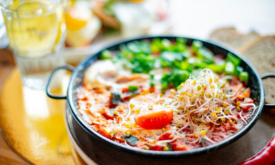 Egg shakshouka dish on a restaurant table